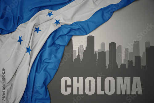 abstract silhouette of the city with text Choloma near waving national flag of honduras on a gray background. 3D illustration