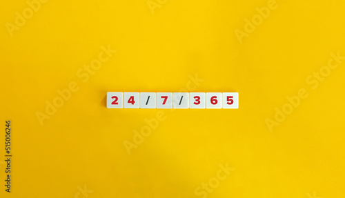 24/7/365 Service. Expression on Letter Tiles on Yellow Background. Minimal Aesthetics.