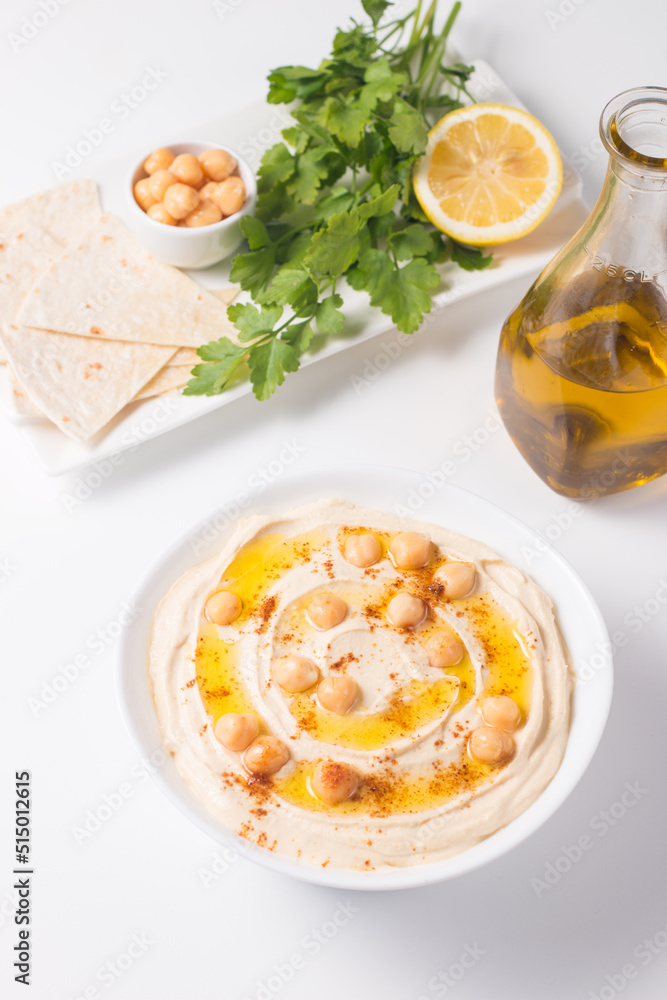 Hummus in a plate with chickpeas, smoked paprika, olive oil and pita. Vegetarian food. Hummus in a plate with chickpeas, smoked paprika, olive oil and pita. Vegetarian food.