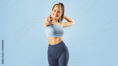 Portrait of happy fitness young woman smiling while exercising.