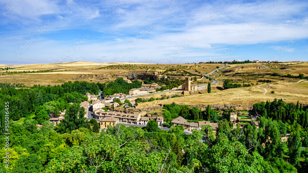 Panoramic of the outskirts of the medieval city of Segovia with churches and picturesque houses in the countryside.