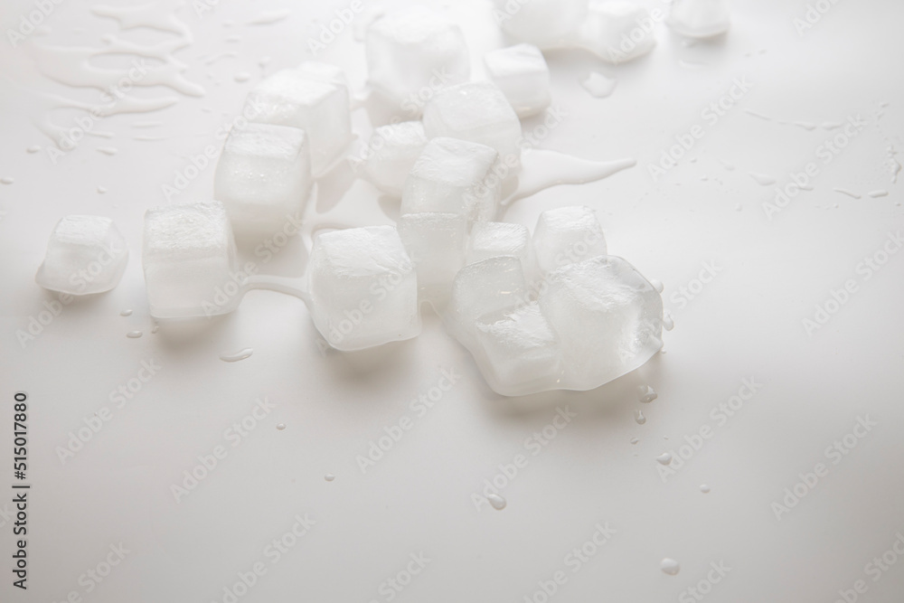 Ice cubes with water drops scattered on a white background. Side view Ice cubes with water drops scattered on a white background. Side view