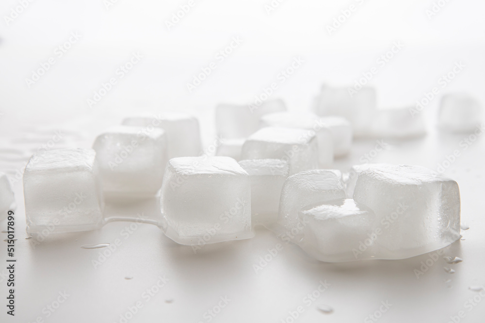 Ice cubes with water drops scattered on a white background. Side view Ice cubes with water drops scattered on a white background. Side view