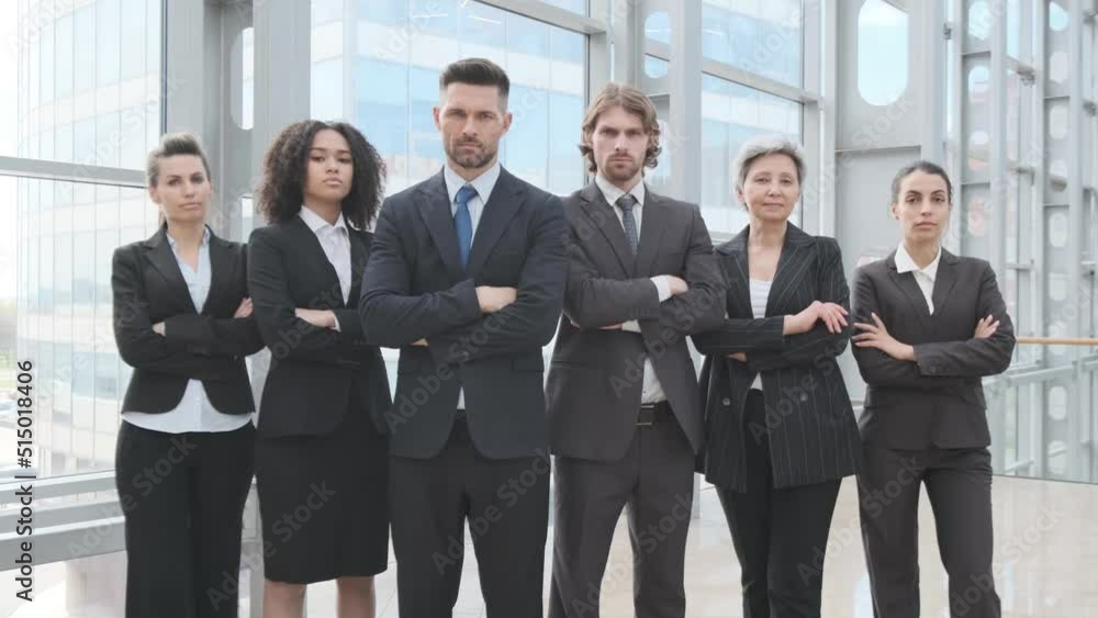 Group portrait of business people with businessman leader on foreground in office Group portrait of business people with businessman leader on foreground in office