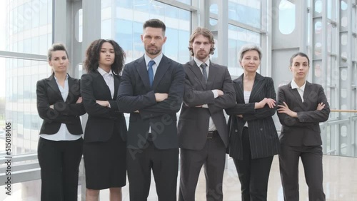 Group portrait of business people with businessman leader on foreground in office