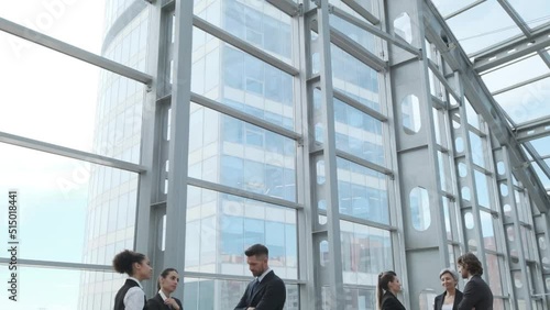 Diverse business people working together, office interior and skyscrapers. Concept of modern office with managers, partners