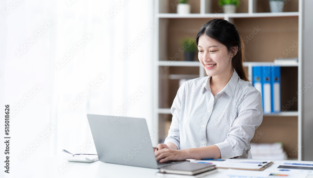 Asian woman working with laptop in her office. business financial concept. Asian woman working with laptop in her office. business financial concept.