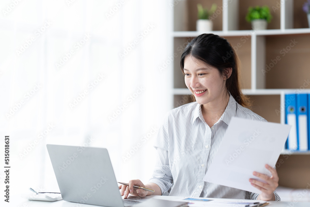 Asian woman working with laptop in her office. business financial concept. Asian woman working with laptop in her office. business financial concept.