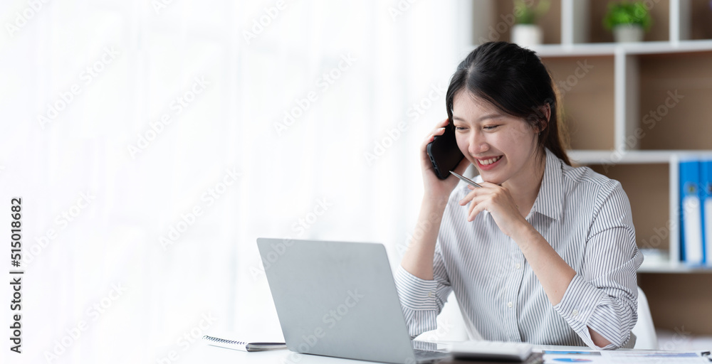 Asian businesswoman in formal suit in office happy and cheerful during using smartphone and working. Asian businesswoman in formal suit in office happy and cheerful during using smartphone and working.