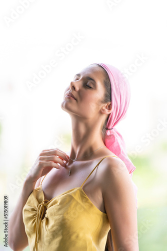 Картината върху платно Beautiful woman claiming cancer with a pink veil on her head