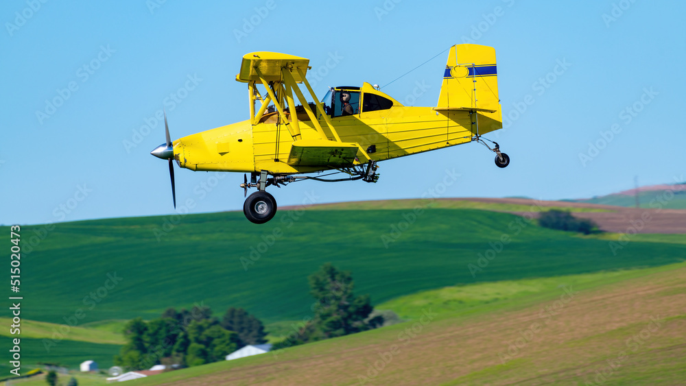 Crop duster airplane flies over the fields of the Palouse Crop duster airplane flies over the fields of the Palouse