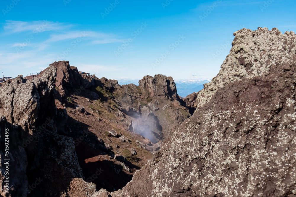 Panoramic view on the edge of the active volcano crater of Mount Vesuvius, Province of Naples, Campania region, Southern Italy, Europe, EU. Volcanic landscape full of stones, ashes and solidified lava Panoramic view on the edge of the active volcano crater of Mount Vesuvius, Province of Naples, Campania region, Southern Italy, Europe, EU. Volcanic landscape full of stones, ashes and solidified lava