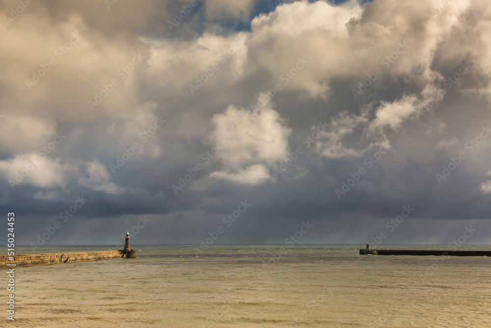 Tynemouth Pier and the Lighthouse guarding the mouth of the River Tyne on a cloudy day