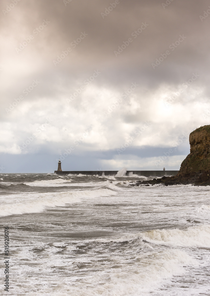 Looking across King Edwards Bay at the rough seas on a cloudy day at Tynemouth, England