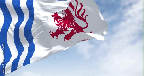 The flag of Nouvelle-Aquitaine waving in the wind on a clear day photo