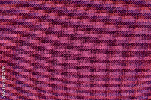 The texture of the fabric is purple, burgundy. Background made of red material with small straight lines