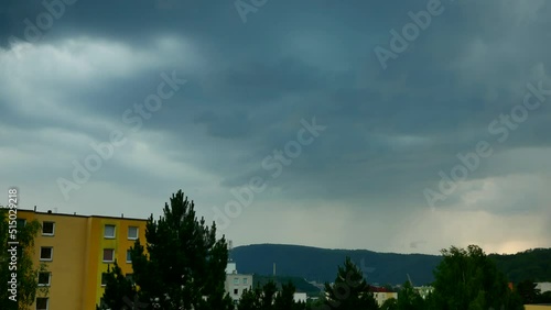 Storm with lightning strike over the hill behind the city Usti nad Labem, Czech Republic.
