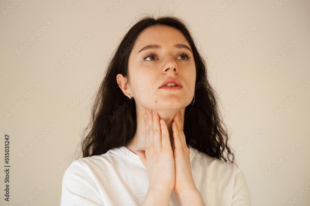 Laryngitis first symptoms throat ache. Sick attractive girl touches throat with pain. Seasonal illness medecine. Laryngitis first symptoms throat ache. Sick attractive girl touches throat with pain. Seasonal illness medecine.