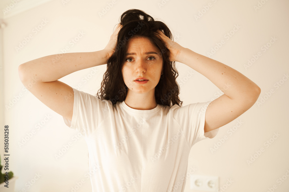 Sad woman with migraine strong headache disease. Depression. Overstressed woman with head pain touches head. Sad woman with migraine strong headache disease. Depression. Overstressed woman with head pain touches head.