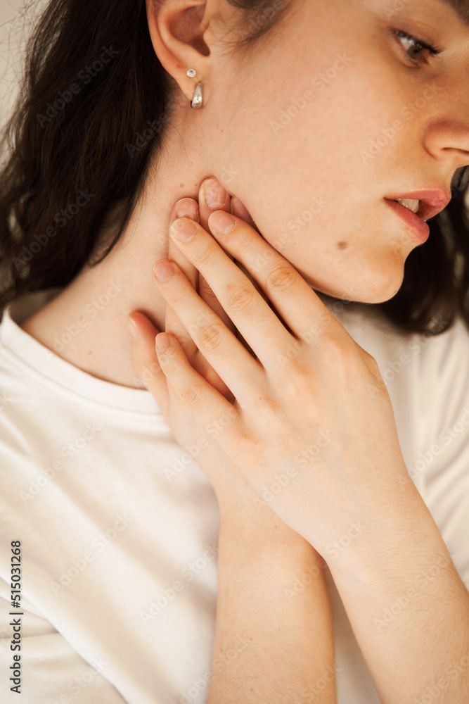 Sick attractive girl touches throat with pain. Laryngitis first symptoms throat ache. Seasonal illness medecine. Sick attractive girl touches throat with pain. Laryngitis first symptoms throat ache. Seasonal illness medecine.