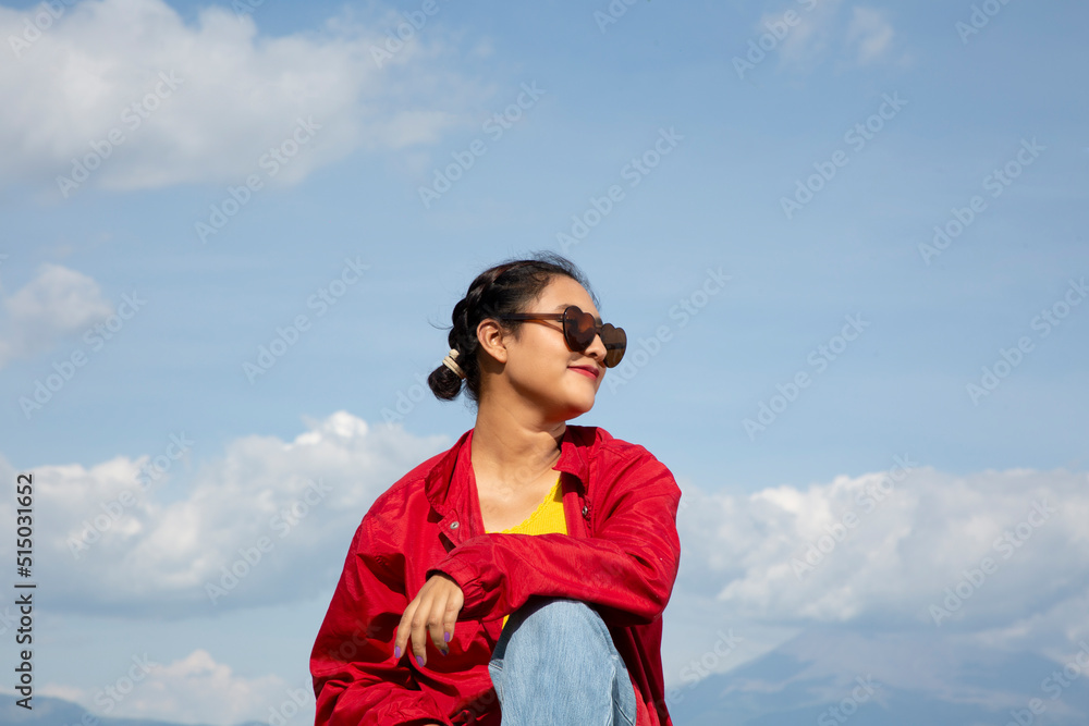 mexican teenage woman with heart-shaped glasses in sky and cloudscape mexican teenage woman with heart-shaped glasses in sky and cloudscape