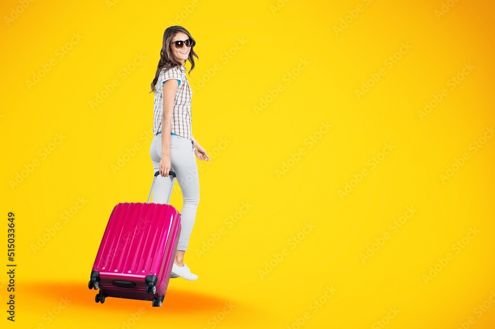 Happy young woman running and holding baggage Happy young woman running and holding baggage