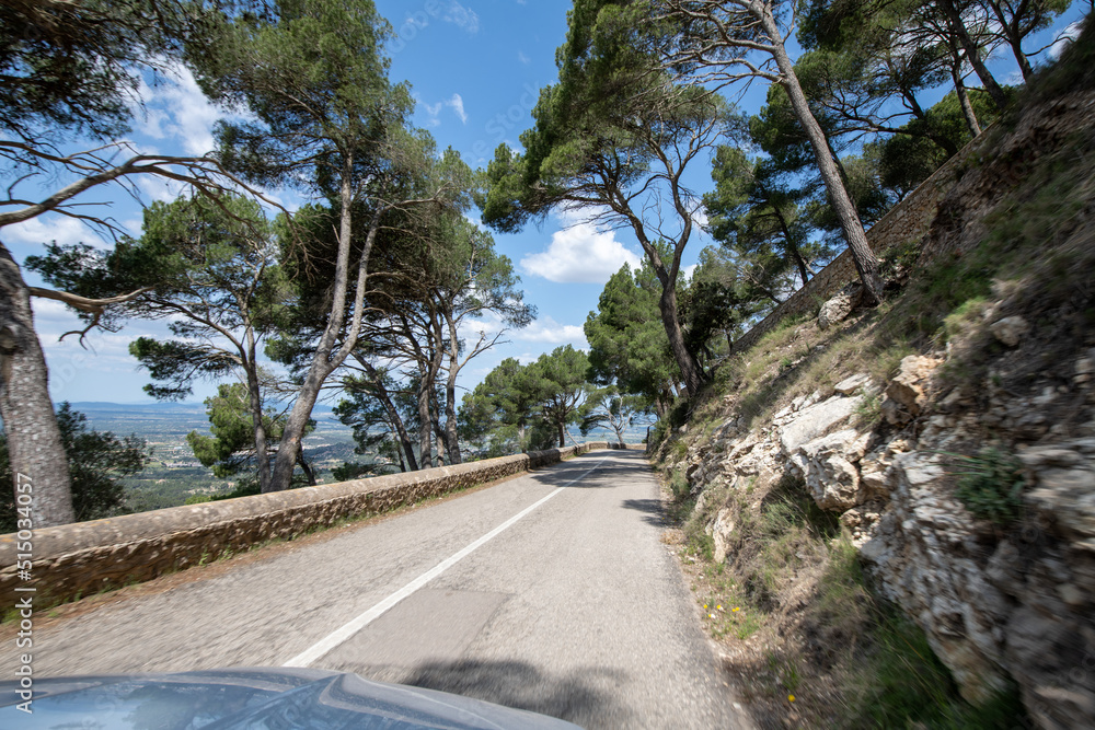 Traveling by car in sunny weather on the serpentine roads of Mallorca.