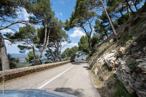 Traveling by car in sunny weather on the serpentine roads of Mallorca.