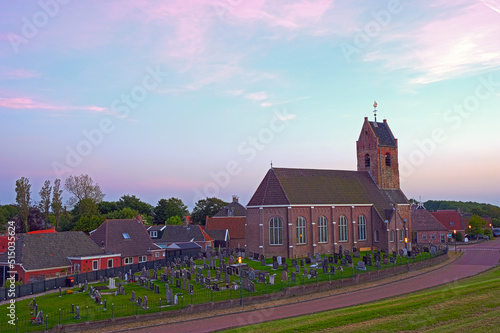 The traditional village Wierum at the Wadden Sea at sunset in Friesland the Netherlands photo