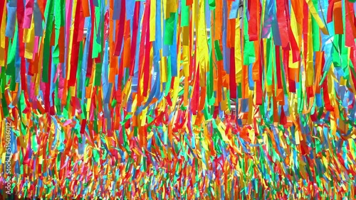 decorative multicolor ribbons waving in the wind at city street holiday, festival or carnival. City festival background