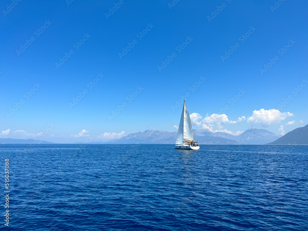 Boat with sails up sailing on the Mediterranean Sea. Sailing vessel velier on mediterranean sea. Sailboat regatta in Greece on the coastline. Travel by boat on the sea. Go Everywhere
