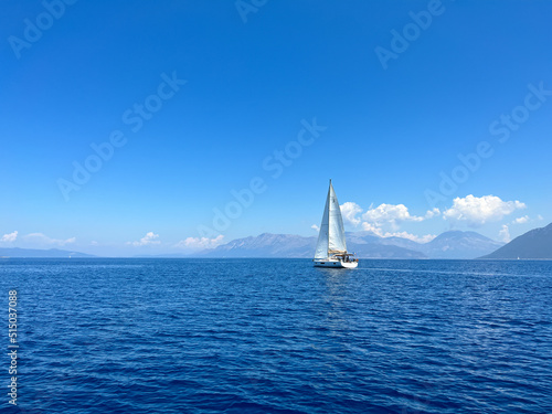 Boat with sails up sailing on the Mediterranean Sea. Sailing vessel velier on mediterranean sea. Sailboat regatta in Greece on the coastline. Travel by boat on the sea. Go Everywhere