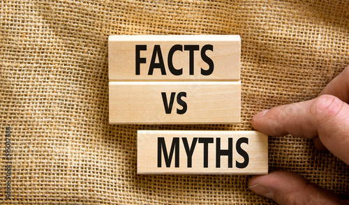 Facts vs myths symbol. Concept words Facts vs myths on wooden blocks on a beautiful canvas table canvas background. Businessman hand. Business, finacial and facts vs myths concept. Copy space. photo