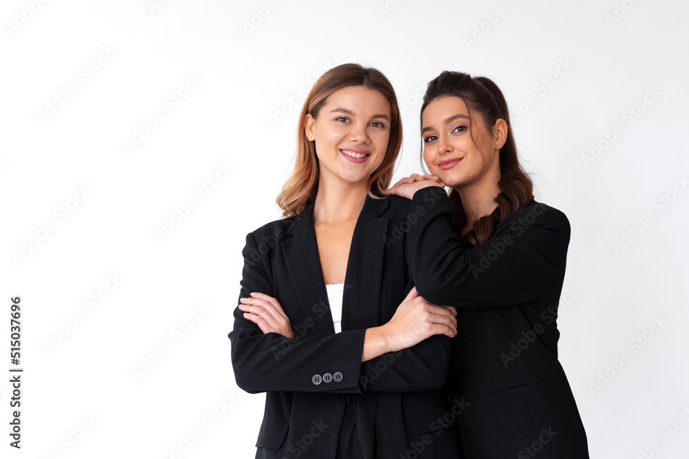 Concept of partnership in business. Two Young businesswoman dressed black formal suit standing studio isolated white background. Concept of partnership in business. Two Young businesswoman dressed black formal suit standing studio isolated white background.