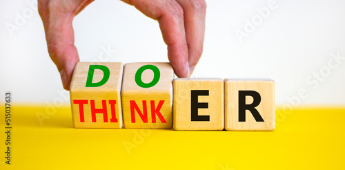 Doer or thinker symbol. Concept words Doer or thinker on wooden cubes. Businessman hand. Beautiful yellow table white background. Business and doer or thinker concept. Copy space. photo