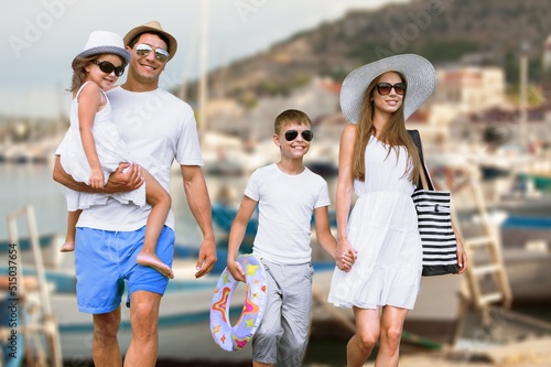 Happy young family walking on the beach