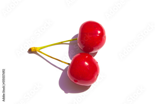 two twin cherries lie on a white background