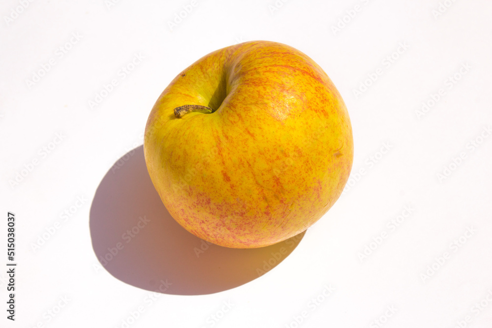 yellow organic apple lies on a white background yellow organic apple lies on a white background