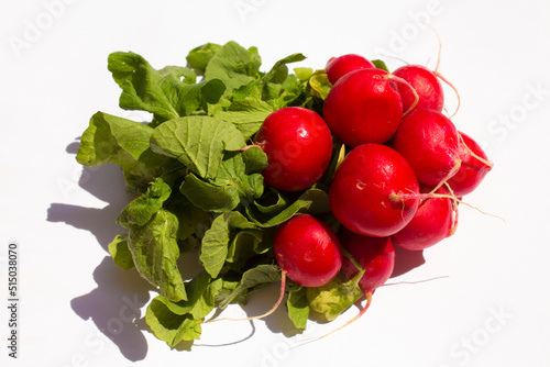 red small radish lies on a white background