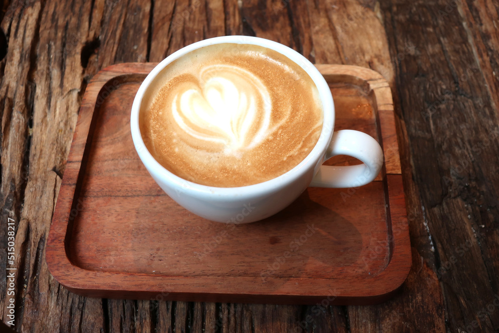 Cappuccino cup an wooden tray, close up Cappuccino cup an wooden tray, close up