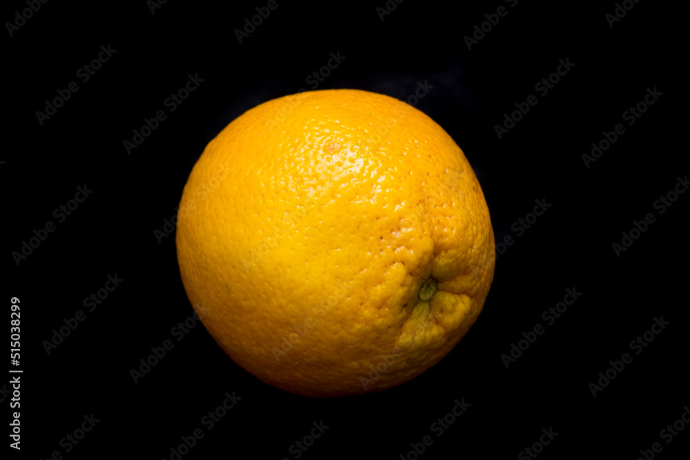 the orange is lying on a black background