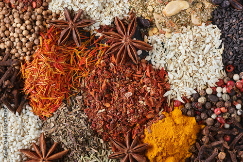 Spices. Aromatic Indian spices as background. Spices and herbs on a stone background. Assortment of Seasonings, condiments, Dry colorful condiments. Culinary, cooking ingredients. Top view, Flat lay