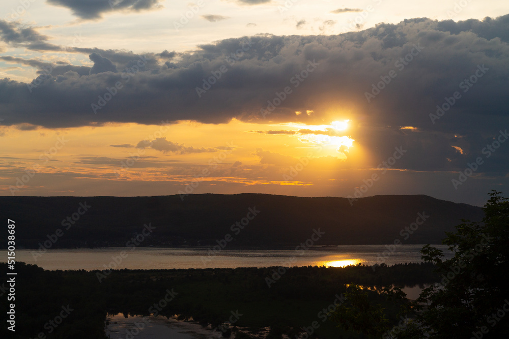 sunset over the river. Landscape with sunset on the lake in summer. bright sunset sky with colourful clouds sunlight