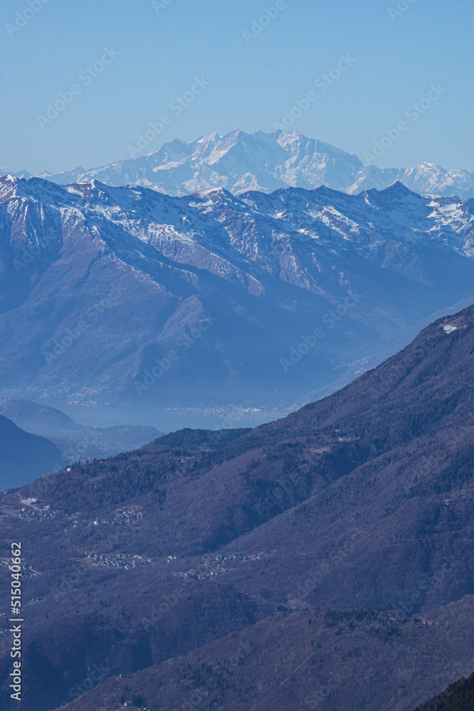 The mountains of Valtellina during a sunny winter day, near the town of Sondrio, Italy - January 2022