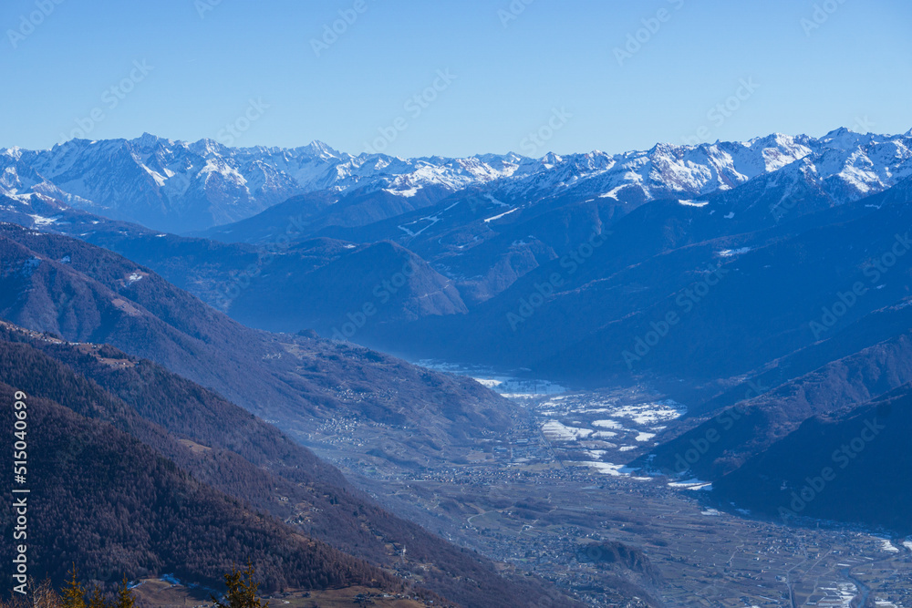 The mountains of Valtellina during a sunny winter day, near the town of Sondrio, Italy - January 2022