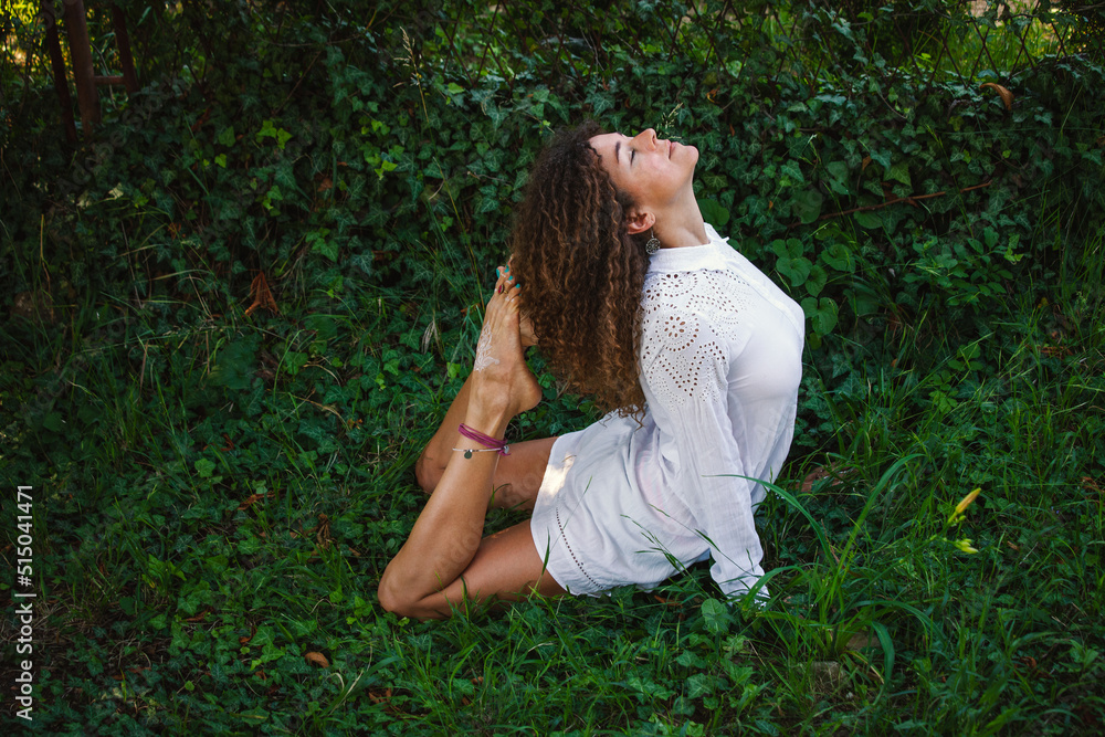 young woman practices yoga in her backyard young woman practices yoga in her backyard