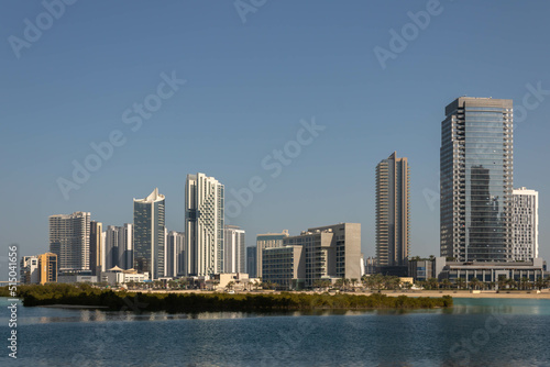  Modern high-rise residential and office buildings on Al Reem island and sea water with mangrove trees in Abu Dhabi  UAE