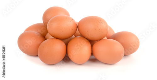 Fotografie Chicken egg pile on a white background.