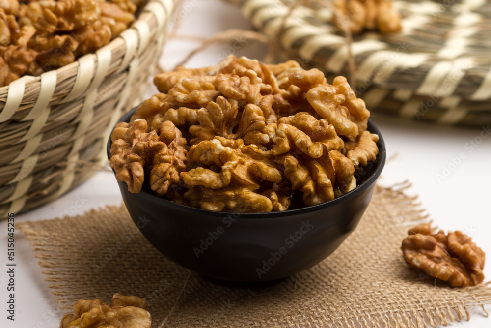 walnut served in a bowl isolated on napkin side view of nuts on grey background walnut served in a bowl isolated on napkin side view of nuts on grey background