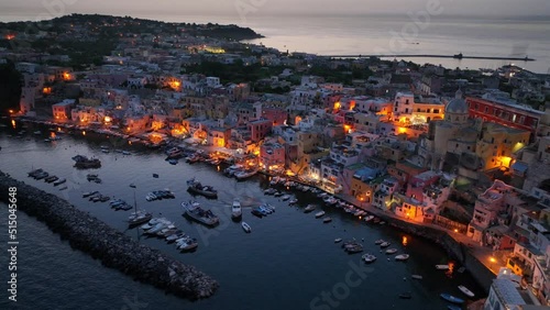 island of Procida at night near Naples in the Mediterranean Sea, aerial view of Italian historical fishermen village on Procida in the evening photo